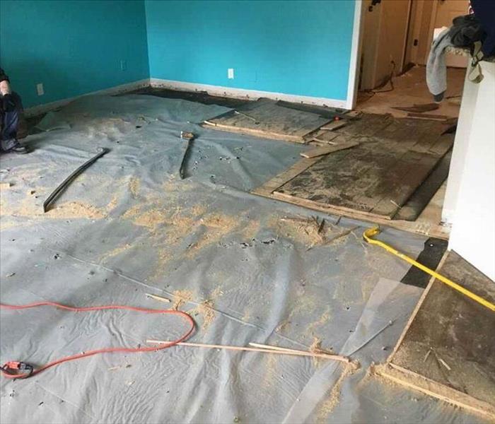 Flooring with padding being removed.