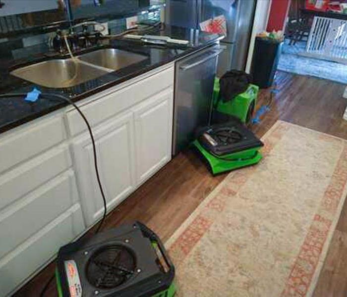 Kitchen with air movers after leak