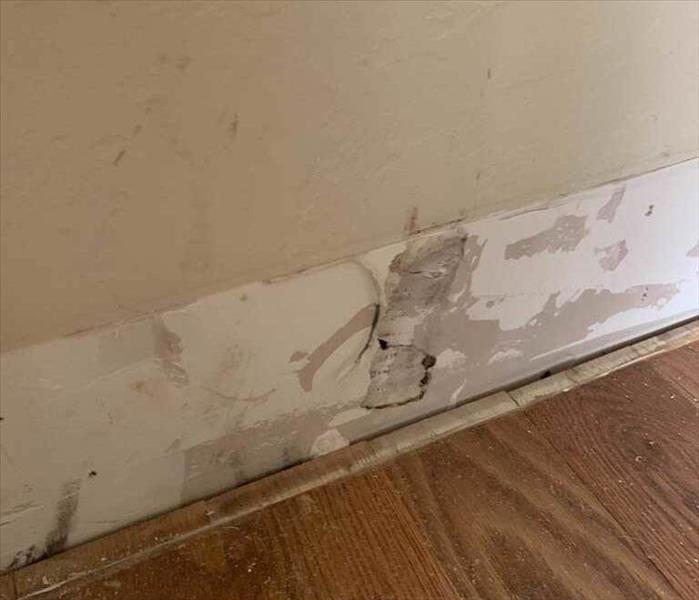 Discolored drywall with wood floors.