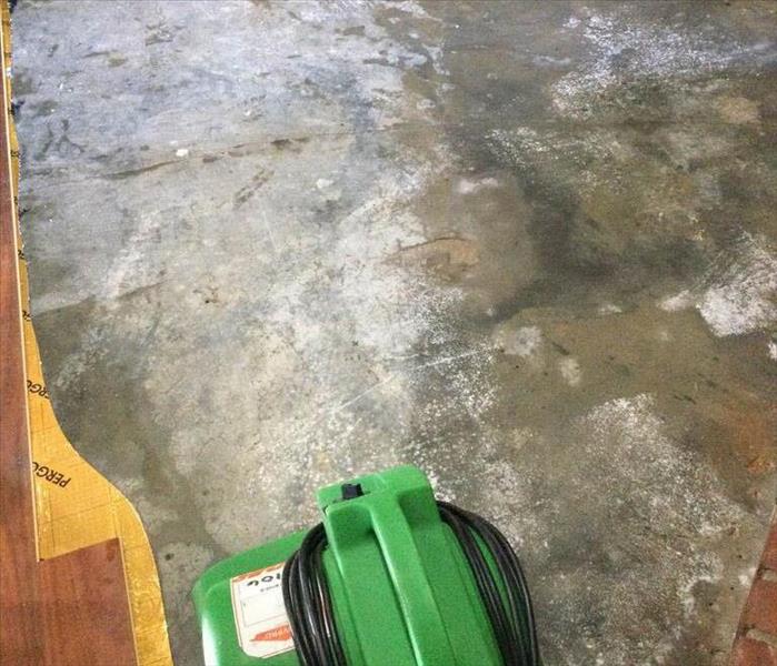 Green air mover on a concrete floor. 