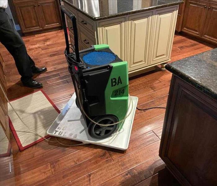 Kitchen with a green dehumidifier.